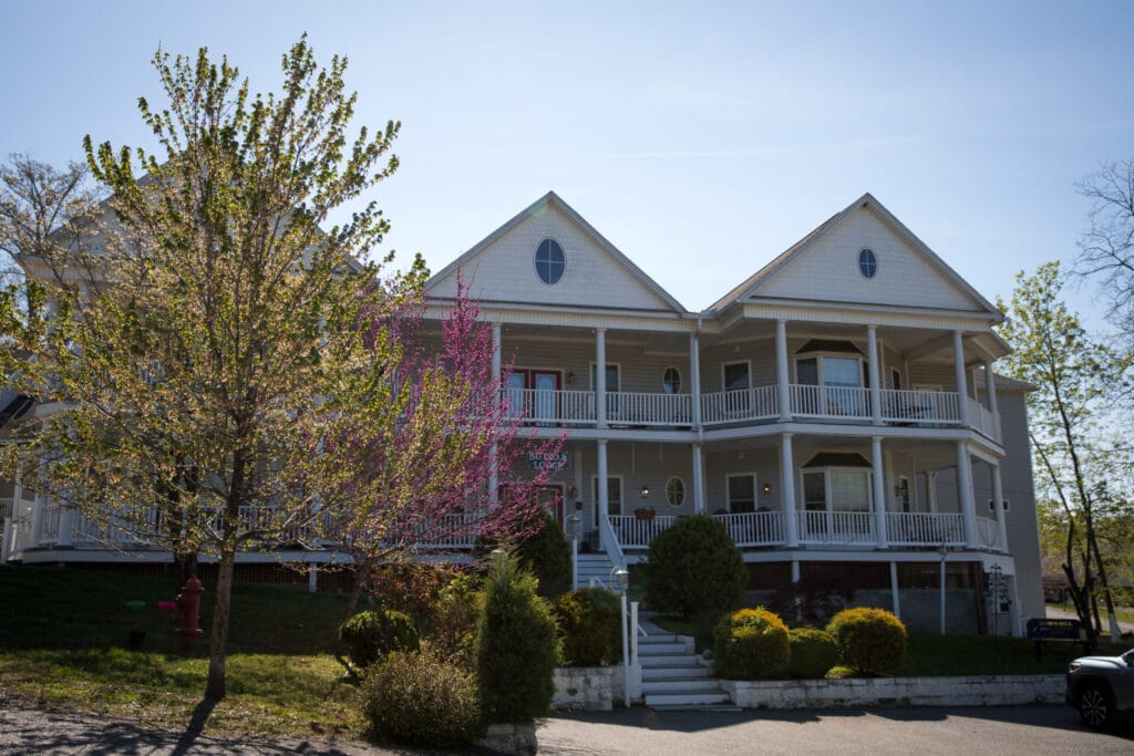 Exterior of Acorn Hill Lodge with trees framing the building