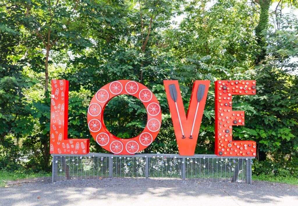 The red LOVE sign surrounded by greenery