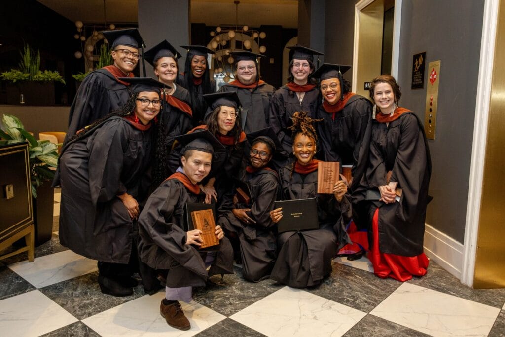 Group of Randolph College graduates in their caps and gowns