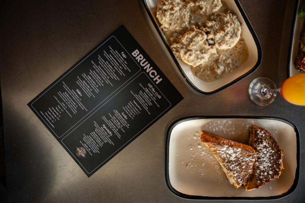 The Vaughan Garage - biscuits and French toast sitting on table, brunch menu shown laying flat on table