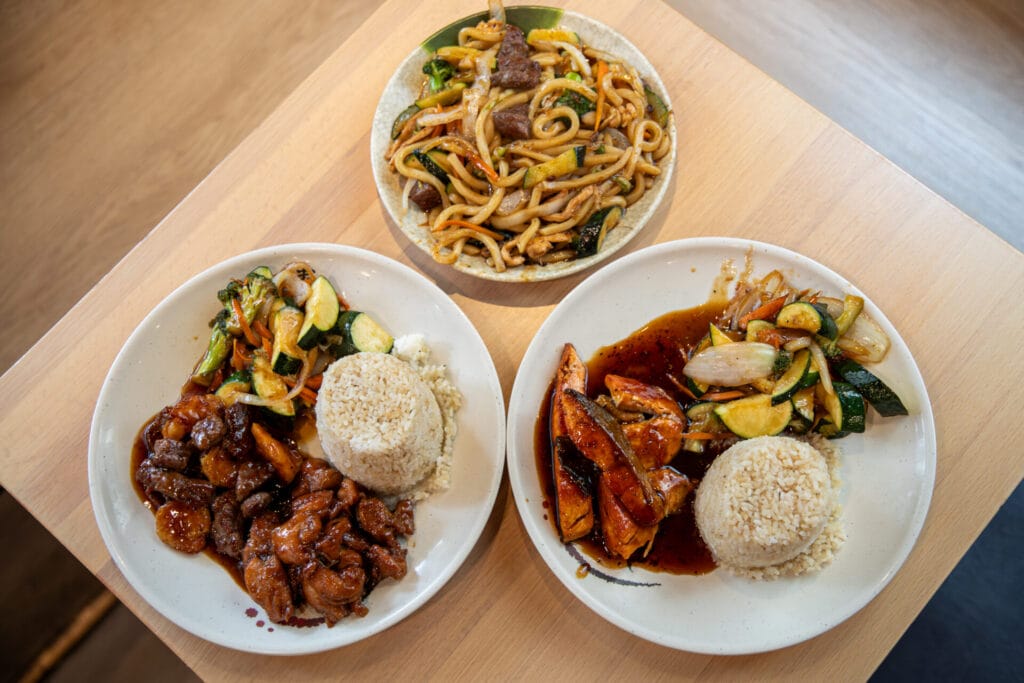 three hibachi dishes plated on the table