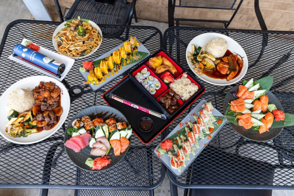 Sushi, hibachi dishes, and sushi pops spread out on the table