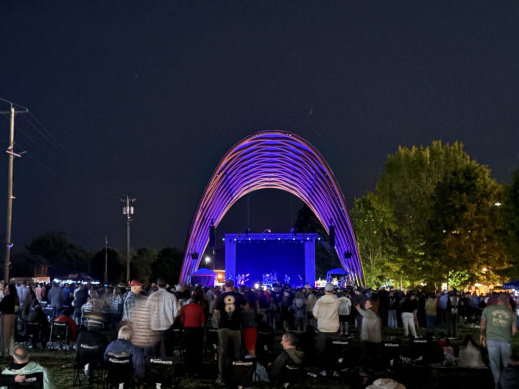 Night time Exterior of Lynchburg Amphitheater with people sitting out on the lawn