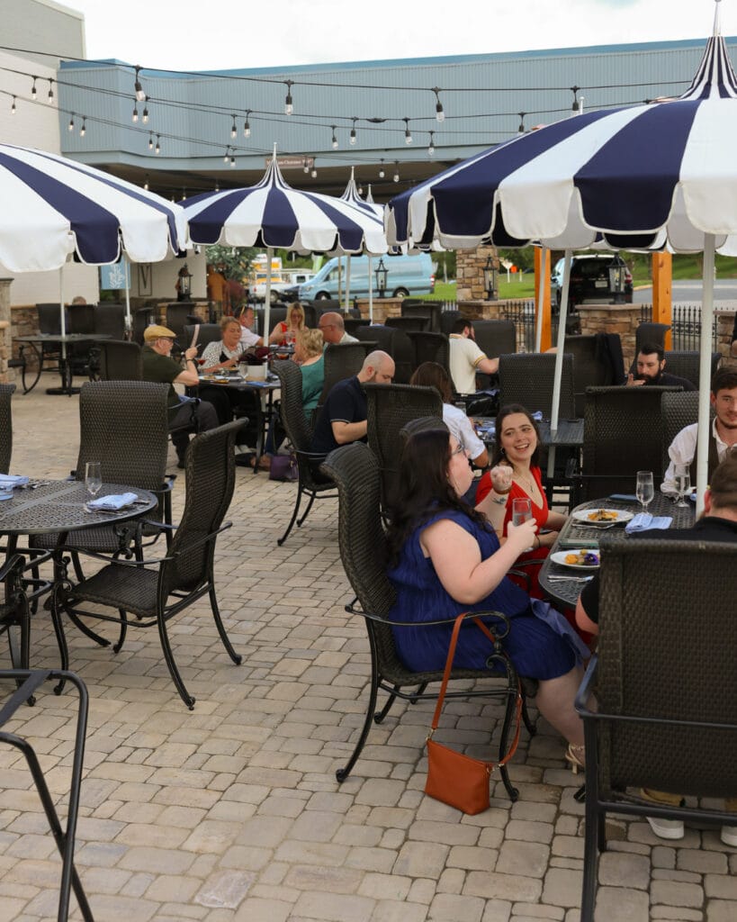 People sitting outside dining; exterior of Tori Blue