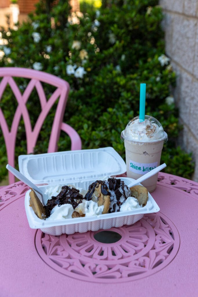 Ice cream sundae and milkshake sitting on light pink table