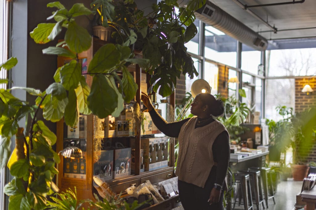 Interior of Palmera House, girl shopping surrounded by greenery