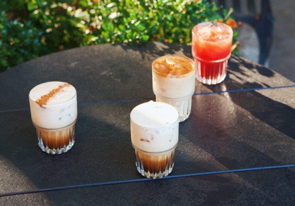 Colorful fall coffee drinks sitting on black table